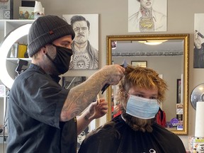 Blackwater Barbershop owner Steve Smith cuts a client’s hair following the announcement Huron-Perth has moved into the yellow zone. Jesse Lambert