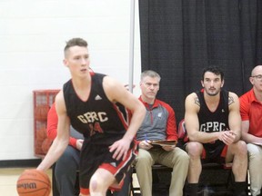 Grande Prairie Composite Tomahawks head basketball coach Troy Sandboe (seated in the middle during a GPRC Wolves men’s basketball game) won the 2020 Alberta Schools’ Athletic Association North West Zone Award of Merit for his service to Grande Prairie Composite Tomahawks athletics.