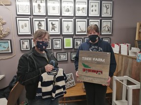 Partners behind the Christmas Store in Ripley, Diane MacDonald and Bonnie McDonnell-Maschke, show off some work from their new artists, including pebble art, signs and knitting in photo. Hannah MacLeod/Lucknow Sentinel