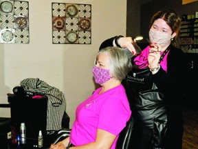 Liv Cavers-Campbell cuts Suzy Love's hair on Nov. 13, when the Hair Hut donated all proceeds from that day's business to Linda Bexte. STEPHEN TIPPER