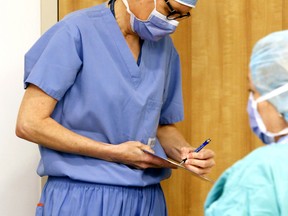 Registered nurse Chris Dassylva, left, and registered practical nurse Paula Santos run through a checklist of surgical instruments in 2014 at Belleville General Hospital. Quinte Health Care's waiting list for surgery is shrinking due in part to the addition of extra operating times.