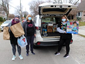 Mindy Bowls (left), Myrna Panjer and Julia Snelgrove, 13, were busy collecting donations of food and toys during The Gift CK event held across Chatham-Kent on Nov. 21. Ellwood Shreve/Postmedia Network