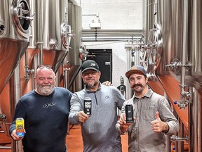 Sons of Kent Brewing Company won gold, silver and bronze at the Ontario Brewing Awards. Brewery partners Tim Copeland (left) holds the Juice Box, which won silver, Doug Hunter, centre holds the Don't Panic hazy IPA that took silver, and Colin Chrysler holds the Scotch Ale that won the Chatham-based craft brewery a gold medal. Handout