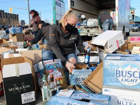 Owner Molly Hartman sorts donations during a Nov. 14 bottle drive Sarnia's On The Dot Deliveries organized to benefit the United Way of Sarnia-Lambton. File photo/Postmedia Network