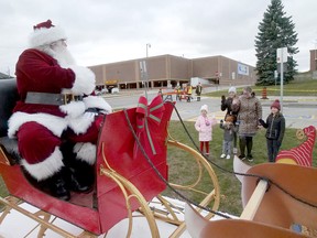 A young family greets Santa Claus Saturday in Tillsonburg at the Optimist Club Christmas Display. (Chris Abbott/Norfolk and Tillsonburg News)