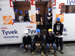 Students and staff at the tiny house under construction in a Brockville warehouse. Wayne Lowrie/Recorder and Times