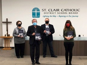 St. Clair Catholic District School Board trustee Carol Bryden, left, supervisor of communications and community relations Todd Lozon, board chairman John Van Heck, Roman Catholic Diocese of London archivist Deb Majer and director of education Deb Crawford hold copies of a new book on the history of Catholic education in Kent and Lambton counties. (Contributed Photo)