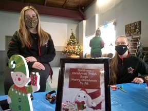 Emily Christiaens (left) and Genevieve Jamieson from Danscene were among the volunteers who helped Saturday at Children Shop for Christmas in Tillsonburg. (Chris Abbott/Postmedia News)