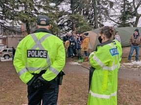 North Bay police officers watch Shane Moyer and supporters partake in an Indigenous ceremony in tent city. The final tent was removed at 7:20 p.m., just steps away from city hall. Moyer and his supporters had a 2 p.m. deadline, but police and the city's bylaw officer extended it.
Jennifer Hamilton-McCharles, The Nugget