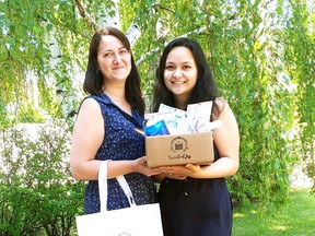 Longridge, left, poses with her daughter Winnie and some of the products available in their subscription service based in Spruce Grove and called Bundle of Joy.