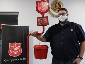 Lt. Brad Webster stands with one of the red donation kettles at the Salvation Army in Sarnia. The kettle campaign has begun in Sarnia and the goal is to collect $140,000 in donations.