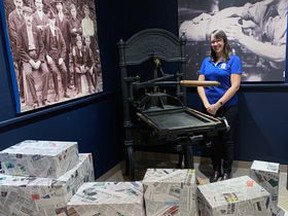 Curator Natalie Wood puts the final touches on the Brockville MuseumÕs exhibit on The Recorder and Times.