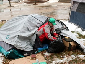 Andre Bessette packs up his belongings after the city ordered the tents set up next to city hall be taken down, Thursday. Bessette has been homeless since the beginning of the month.
PJ Wilson/The Nugget