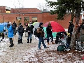 Homeless people living in tents behind North Bay City Hall and representatives of various services meet at the tent city, Thursday morning.
PJ Wilson/The Nugget