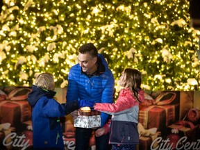 Bill Given, Grande PrairieÕs mayor, lights up the Grande Prairie City Centre Christmas tree for a Facebook live event with the help of his children Paja, 7 and Mila, 8 in front of Revolution Place  on Sunday.