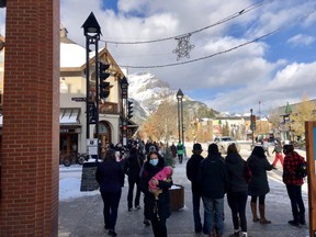 Pedestrians walk down Banff Avenue on Saturday Nov. 21. despite Banff and Lake Louise reporting growing active cases of COVID-19. Photo Marie Conboy/ Postmedia.