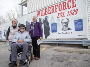 Ed Butler, his wife Annelies (left) and his niece Marlene Thornton attend the official unveiling of a mural in Lucan on Friday commemorating the former Wilberforce Colony of escaped Black slaves who made their way north on the Underground Railroad. Butler and Thornton's ancestor, Peter Butler, was an original member of the Wilberforce Colony. Peter's grandson, Peter Butler III, was Canada's first Black police officer. Derek Ruttan/Postmedia Network