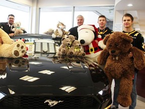 Members of the Sarnia Sting Ryan McGregor, Brayden Guy and Jamieson Rees, Salvation Army Lieutenant Brad Webster and Lambton Ford’s Rob Ravensberg pose with stuffed animals in the build-up to 2019’s Teddy Bear Toss. This year’s Teddy Bear Toss will take place during the drive-thru Sarnia Kinsmen Santa Claus parade which takes place at Lambton College on Dec. 5. File photo/Sarnia This Week