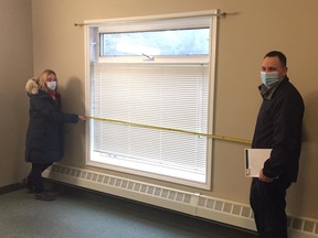Carol Rencheck, Co-Chair of Huron Shores Hospice and Ryan Plante, Local Union Coordinator, measure the room so the Hospice can order supplies. SUBMITTED
