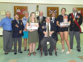Cassandra Hewitt and Meadow Congdon receive certificates of appreciation along with paint and brushes for future endeavours from members of the Royal Canadian Legion Renfrew Branch and Ladies Auxiliary executive members who volunteered time to refurbish the Legion Hall. Back row from left, Bill McCleod, service officer,  Irene Rosenburg, Ladies Auxiliary past president,  Susan Fleming, Ladies Auxiliary Secretary,   Bruce Ferguson, first vice president,  Rose Lafont, Ladies Auxiliary president and Robert Marsh, sergeant at arms. Front from left, Cassandra Hewitt, Greg Walbeck, president, and Meadow Congdon. Submitted photo