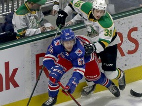 London Knights Max McCue hits Kitchener Rangers Michael Vukojevic behind the Rangers net in London, Ont. on Saturday December 28, 2019.