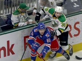 London Knights Max McCue hits Kitchener Rangers Michael Vukojevic behind the Rangers net in London, Ont. on Saturday December 28, 2019.