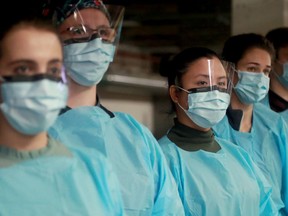 Nurses who'll be performing the nasal swab tests at the new drive thru assessment centre at the National Arts Centre underground parking garage.