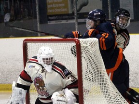 PETER RUICCI/Sault Star

Blind River defenceman Mason Chitaroni (right) ties up Soo Thunderbirds centre Cooper Smyl behind Beavers netminder Wyatt Courchaine in NOJHL pre-season action recently at John Rhodes Community Centre