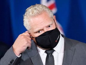 As Ontario posted a record high of 1,855 COVID-19 cases Friday, Premier Doug Ford said the province could receive its first vaccines as early as January. POSTMEDIA PHOTO