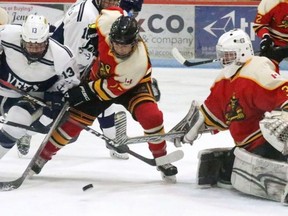 Woodstock Navy Vets forward Kurtis Christo tries to get a shot on Paris Mounties goalie Justin Hergott at Southwood Arena.