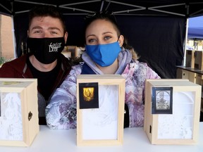 Emma Reaume, right, of Hand Crafted Shadow Boxes in Chatham, Ont., sells her wares with Nick Swan at the annual All I Want For Christmas Expo at Downtown Chatham Centre in Chatham, Ont., on Saturday, Nov. 7, 2020. Mark Malone/Chatham Daily News/Postmedia Network