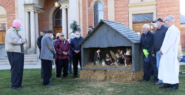 Rev. Bill Capitano, front row, second from left, gives a blessing after members of St. Joseph Knights of Columbus Council 10436 set up a nativity scene at St. Joseph Roman Catholic Church in Chatham, Ont., on Saturday, Nov. 28, 2020. Mark Malone/Chatham Daily News/Postmedia Network