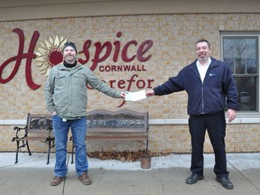 Ian Larkin, coach operator for Cornwall Transit and maintenance supervisor Maurice Rozon were all smiles on Friday November 27, 2020 in Cornwall, Ont., as they presented a $500 donation to the Carefor Hospice Cornwall's annual telethon.  Francis Racine/Cornwall Standard-Freeholder/Postmedia Network