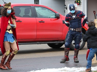 Wonder Woman and Captain America doing some warmup exercises with Connor. Photo on Saturday, November 28, 2020, in Cornwall, Ont. Todd Hambleton/Cornwall Standard-Freeholder/Postmedia Network