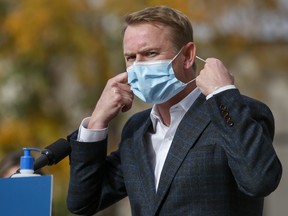 Alberta Health Minister Tyler Shandro removes his mask while announcing a new agreement between Alberta Health Services and a local manufacturer to produce medical equipment in Calgary, Alta. on Wednesday, Oct. 7, 2020. THE CANADIAN PRESS/Jeff McIntosh ORG XMIT: JMC104
