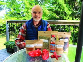 Dan Hood displays his selections of hot peppers, powders, and habanero sauce