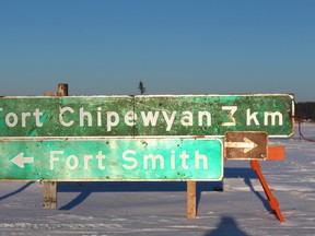 A sign outside Fort Chipewyan directing people to the northern Alberta hamlet and to Fort Smith, NWT. in this December 2014 file photo. Vincent McDermott/Fort McMurray Today/Postmedia Network