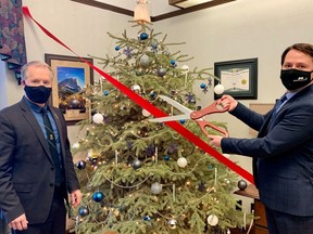 Associate Minister Hunter joins Minister Dreeshen to cut the red tape on Alberta's Christmas trees. Government of Alberta photo