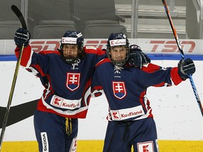 Team Slovakia's Dominik Jendek (right) jubilates with team mate Adam Kormuth (left) after Jendek scored on Team Switzerland during first period game action at the Hlinka Gretzky Cup hockey tournament in Edmonton on August 8, 2018.