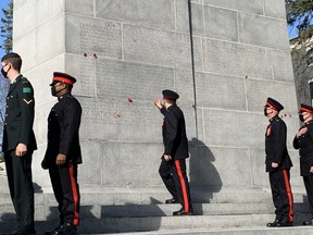 Soldiers from the 56th Field Regiment paid an unofficial visit to the War Memorial Wednesday and lined up to leave their poppies on the walls or on a wreath.