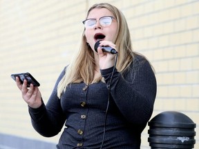 Jerzie Rylett sings outside the LCBO store on St. Clair Street in Chatham, Ont., on Saturday, Nov. 7, 2020. She is collecting donations for ROCK Missions, a charity that helps the homeless and hungry. Mark Malone/Chatham Daily News/Postmedia Network