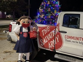 Sally Ann, the Salvation Army mascot, holds up a red kettle during the Kiwanis Owen Sound Santa Claus drive-through parade Saturday. SUPPLIED