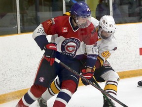 Rayside-Balfour Canadians forward Mitchell Martin (15) battles Timmins Rock defenceman Chris Innes (92) during first-period NOJHL action at Chelmsford Arena in Chelmsford, Ontario on Thursday, November 26, 2020.