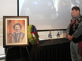 Metis Elder Harvey Sykes pauses after laying a wreath near a portrait of Louis Riel during a ceremony honouring the Metis leader on Friday, November 15, 2019. Vincent McDermott/Fort McMurray Today/Postmedia Network