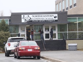 Parents and guardians wait to pick up students at Northeastern Elementary School in Garson, Ontario on Friday, November 13, 2020.