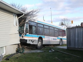A Kingston Transit bus struck the side of a house after being hit by a pickup truck in the intersection of Centennial Drive and Kingsdale Avenue on Saturday, Nov. 28.