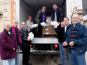 Many hands made light work as volunteers and donors unloaded 60 turkeys donated by the team from Bickerton Brokers Real Estate in Gananoque to the Food Bank at their location on King Street East in Gananoque back in 2010.  L-r, Audrey Jackson, Whitney Kilgore, Bill Helmer, Judy Clark, Emily Bell, Mark Kellogg, Dave Redmond, Dwayne Fletcher and Cliff Weir. 
Lorraine Payette/For Postmedia Network