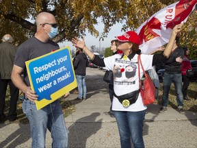 A supporter of public-health measures and an anti-masker talk during dueling protests in Aylmer. Derek Ruttan/The London Free Press