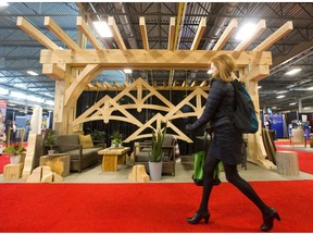 The massive timbers of eastern white pine dominate the display of Alex Oke's Okewood Timberworks at the Lifestyle Homeshow at the Western Fair Agriplex in London Friday. (Mike Hensen/The London Free Press)