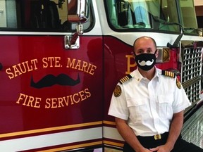 Fire Chief Peter Johnson gets into the Movember act, while practising pandemic precaution.